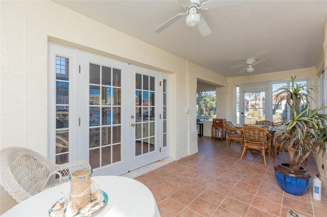 sunroom / solarium featuring french doors and ceiling fan