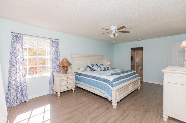 bedroom featuring light wood-type flooring, a textured ceiling, and ceiling fan