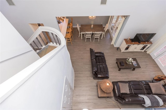 living room featuring an inviting chandelier and hardwood / wood-style floors