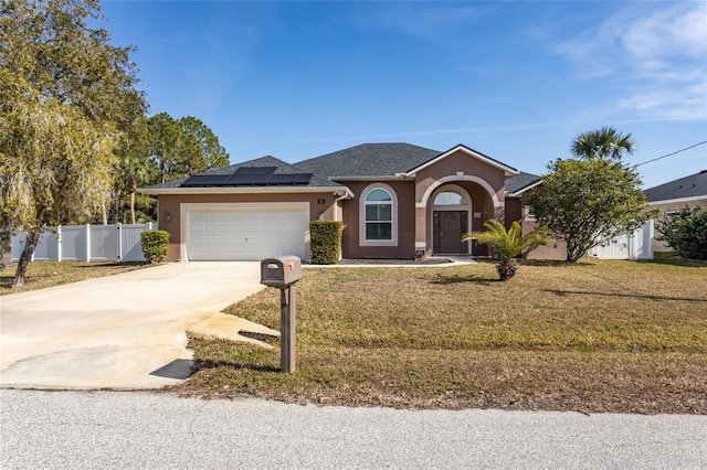 single story home featuring a garage, a front lawn, and solar panels