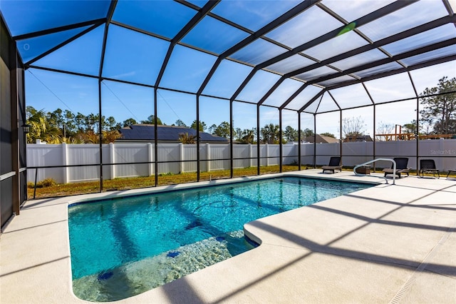 view of pool featuring a patio area and glass enclosure