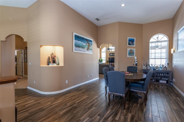 dining area featuring a towering ceiling
