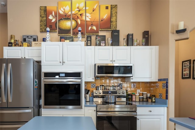 kitchen featuring white cabinetry, tasteful backsplash, and stainless steel appliances