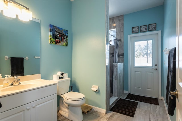 bathroom featuring vanity, toilet, and walk in shower
