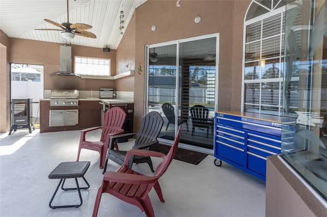 view of patio featuring area for grilling, a grill, and ceiling fan