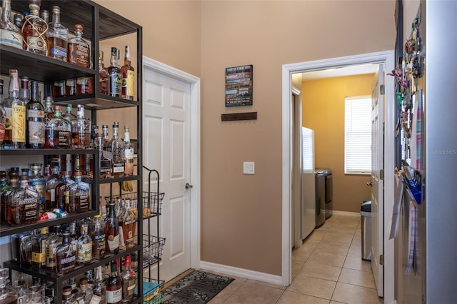 interior space featuring light tile patterned floors and washer and dryer