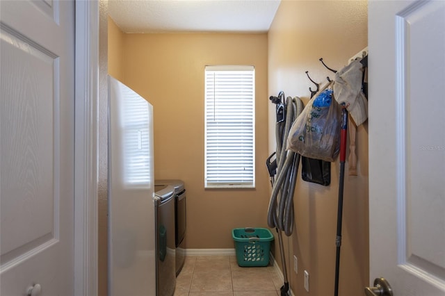 laundry room with light tile patterned flooring and independent washer and dryer