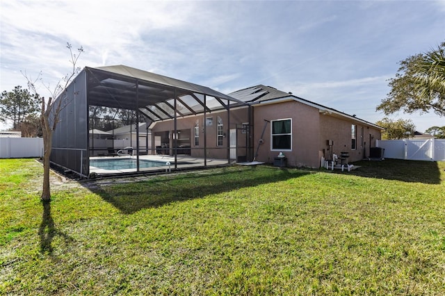 rear view of house featuring a fenced in pool, a lawn, central air condition unit, and glass enclosure