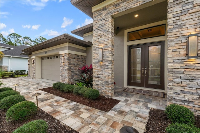 doorway to property featuring a garage and french doors