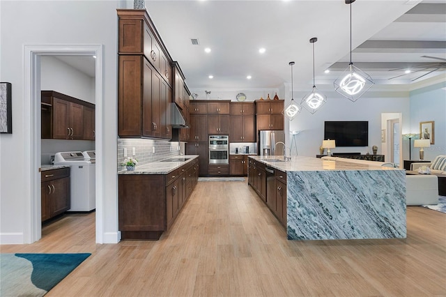 kitchen featuring pendant lighting, dark brown cabinets, stainless steel appliances, and light hardwood / wood-style flooring