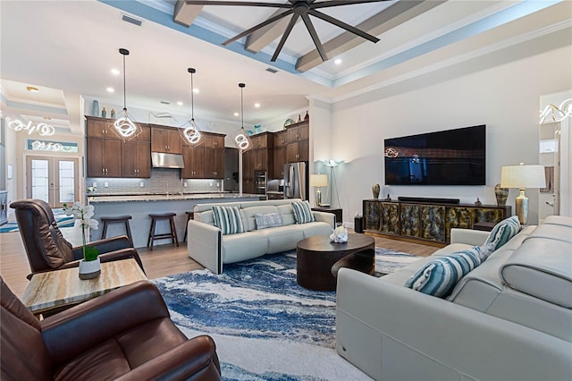 living room with coffered ceiling, crown molding, light hardwood / wood-style flooring, and beamed ceiling