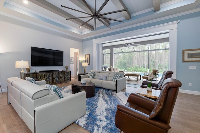 living room featuring ceiling fan, crown molding, beamed ceiling, and light wood-type flooring