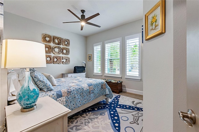 bedroom with ceiling fan and wood-type flooring