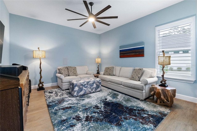 living room featuring hardwood / wood-style flooring and ceiling fan