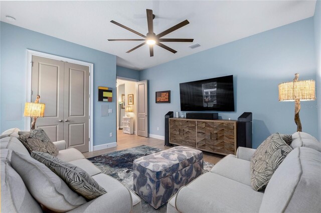 living room featuring ceiling fan and light wood-type flooring