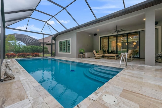 view of swimming pool featuring ceiling fan, an outdoor living space, a patio, and glass enclosure