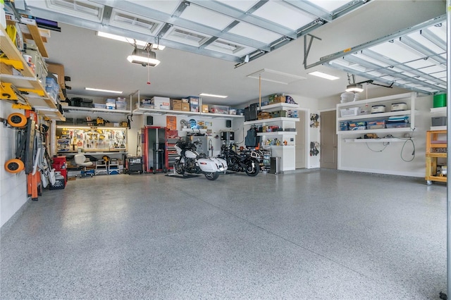 garage featuring a garage door opener and a workshop area