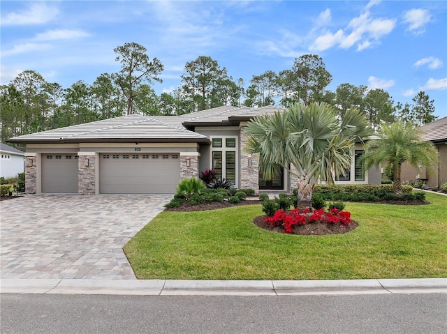 view of front of property with a garage and a front lawn