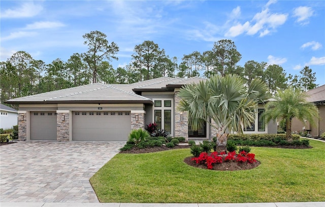 view of front of property with a garage and a front yard