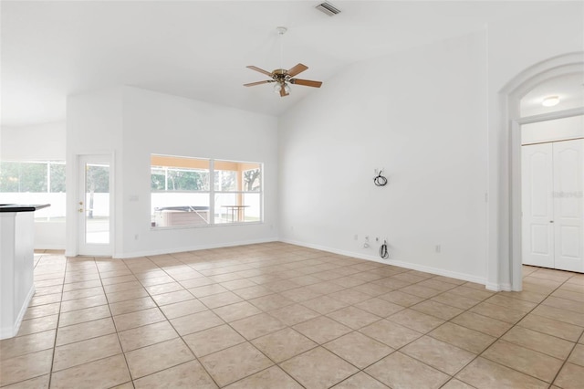 unfurnished living room featuring light tile patterned flooring, ceiling fan, and vaulted ceiling