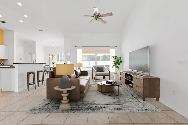 living room with ceiling fan with notable chandelier and light tile patterned floors