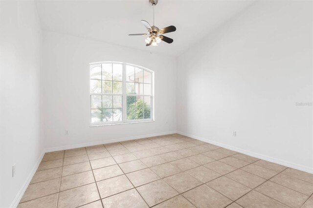 unfurnished room with ceiling fan and light tile patterned flooring