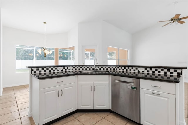 kitchen featuring pendant lighting, sink, light tile patterned floors, white cabinetry, and stainless steel dishwasher