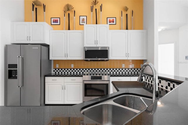 kitchen with white cabinetry, appliances with stainless steel finishes, and decorative backsplash