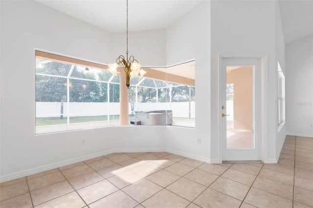 unfurnished dining area with a towering ceiling and light tile patterned floors