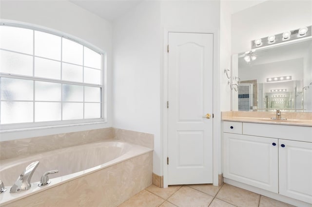 bathroom with tile patterned floors, separate shower and tub, and vanity