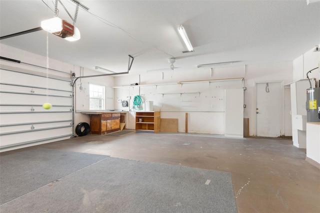 garage featuring a garage door opener and water heater