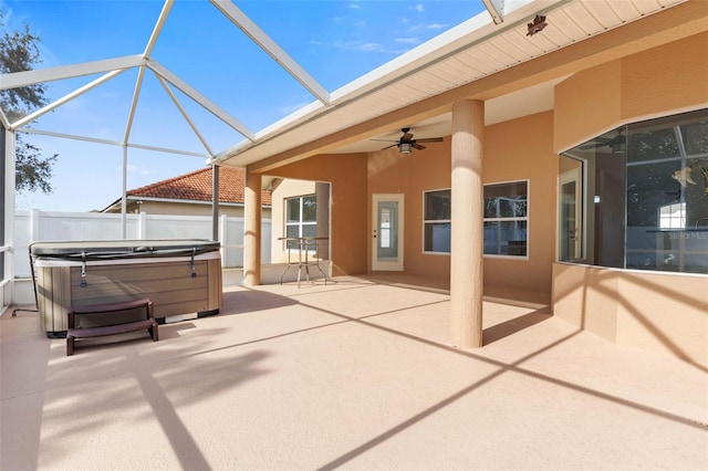 view of patio with ceiling fan, a hot tub, and a lanai