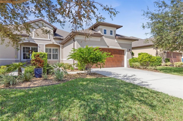 view of front of property featuring a garage and a front yard