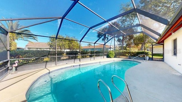 view of pool featuring a patio and glass enclosure