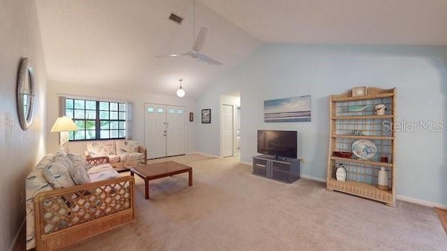 living room with ceiling fan, carpet, and vaulted ceiling