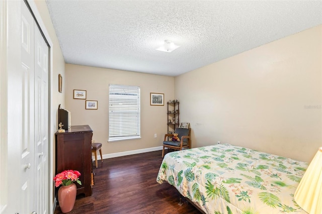 bedroom featuring a textured ceiling, a closet, and dark hardwood / wood-style flooring