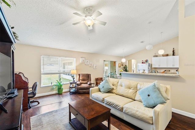 living room with ceiling fan, a textured ceiling, dark hardwood / wood-style flooring, and lofted ceiling