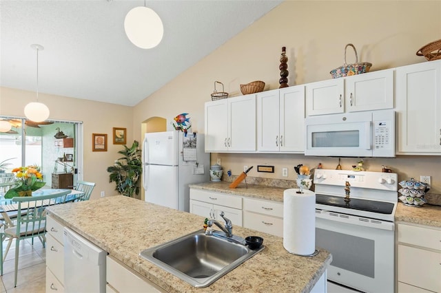 kitchen featuring vaulted ceiling, sink, decorative light fixtures, white cabinetry, and white appliances