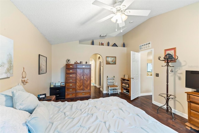 bedroom with ceiling fan, dark hardwood / wood-style flooring, a textured ceiling, and lofted ceiling