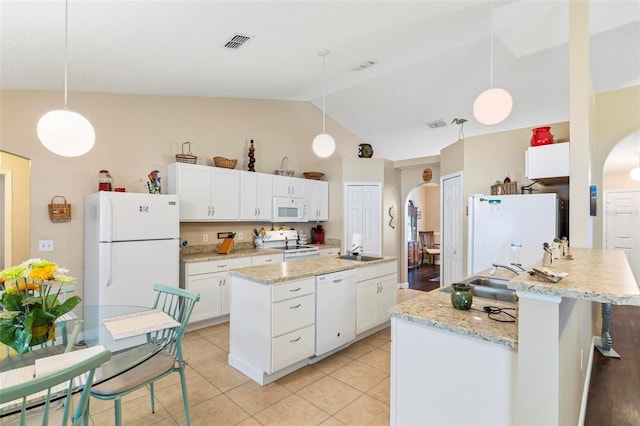 kitchen with sink, hanging light fixtures, and white appliances