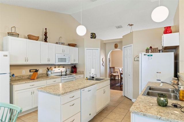 kitchen featuring decorative light fixtures, sink, white cabinets, white appliances, and a kitchen island with sink