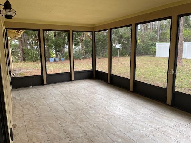 unfurnished sunroom with plenty of natural light