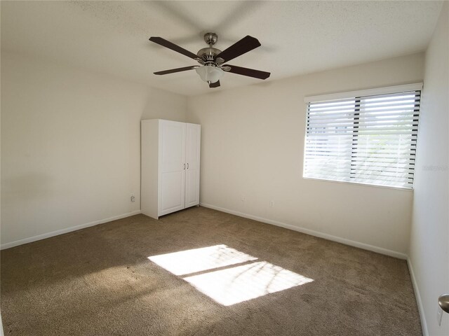 unfurnished bedroom with carpet flooring and ceiling fan