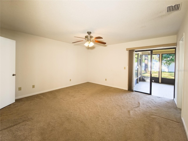 carpeted empty room featuring ceiling fan