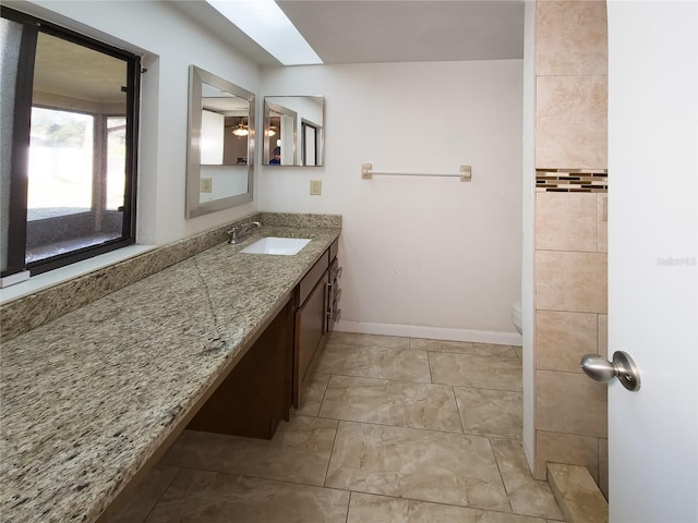 bathroom featuring vanity, tile patterned flooring, and toilet