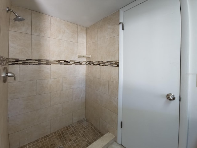 bathroom with a tile shower