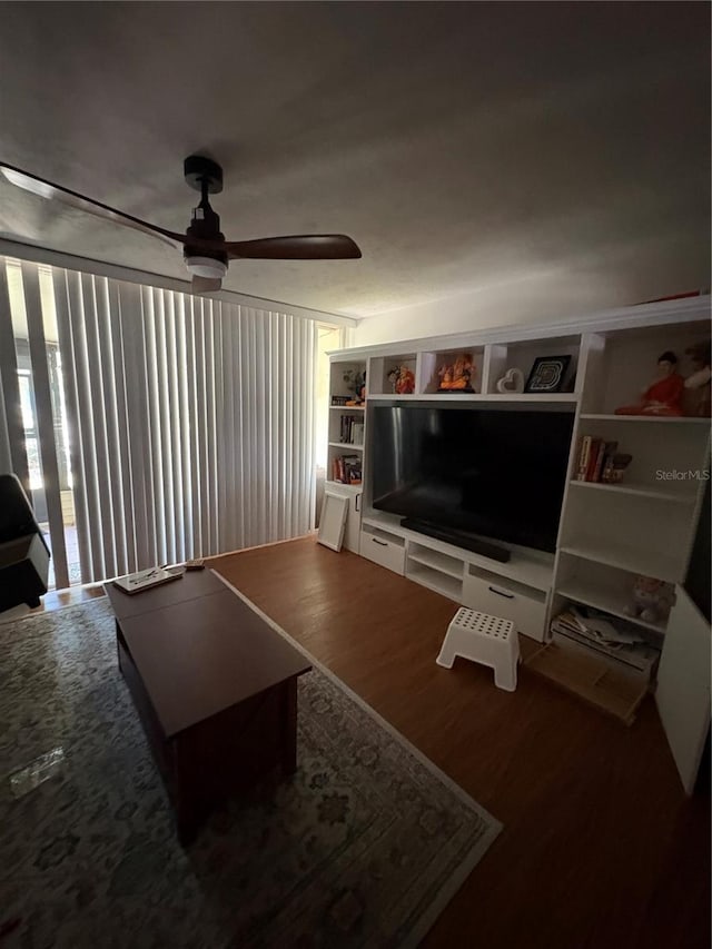 living room with wood-type flooring and ceiling fan