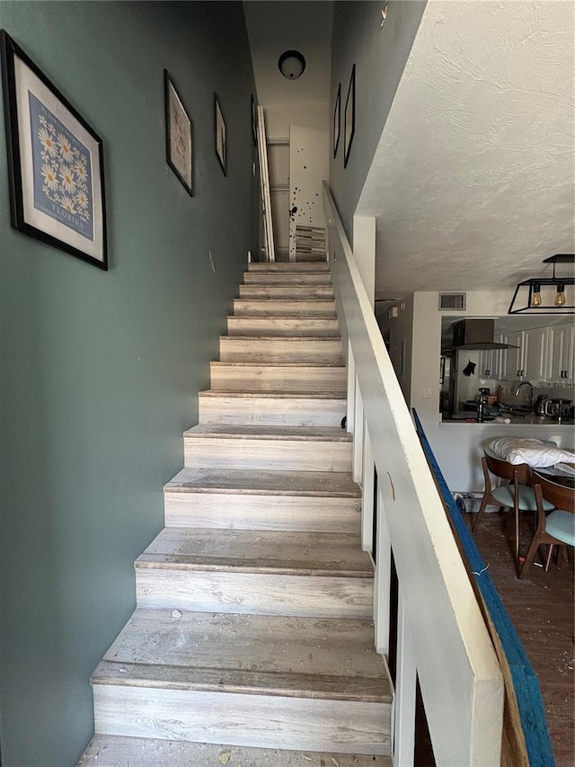 stairs with wood-type flooring