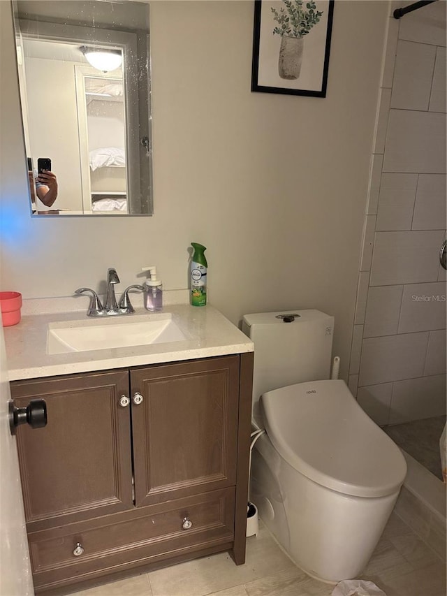 bathroom with walk in shower, vanity, and toilet