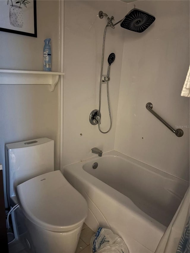 bathroom featuring tile patterned flooring, bathtub / shower combination, and toilet